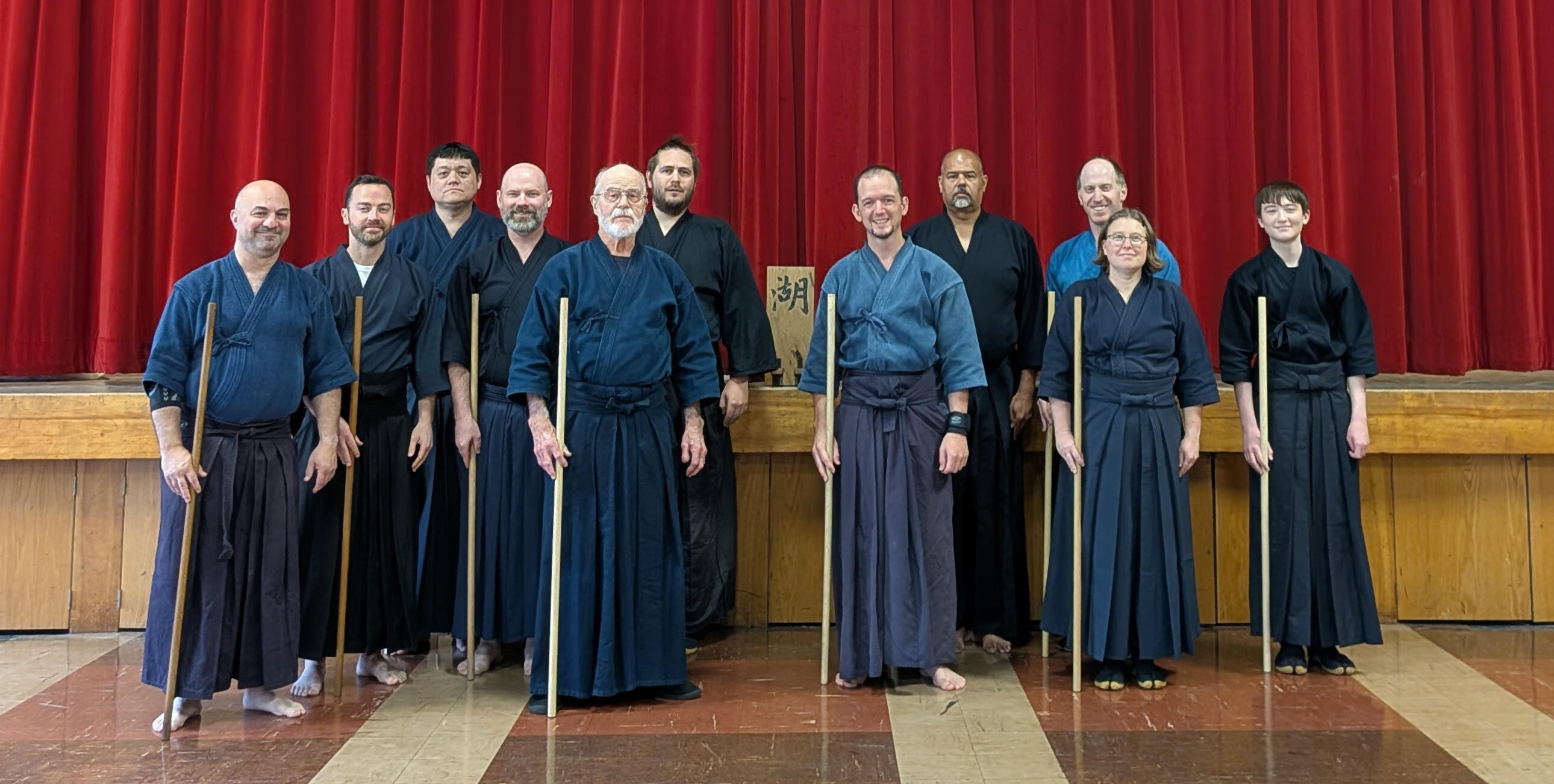 The group, lined up with their weapons